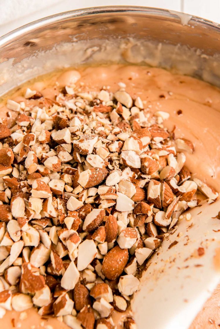 Chopps almond being adding into a pan of toffee.