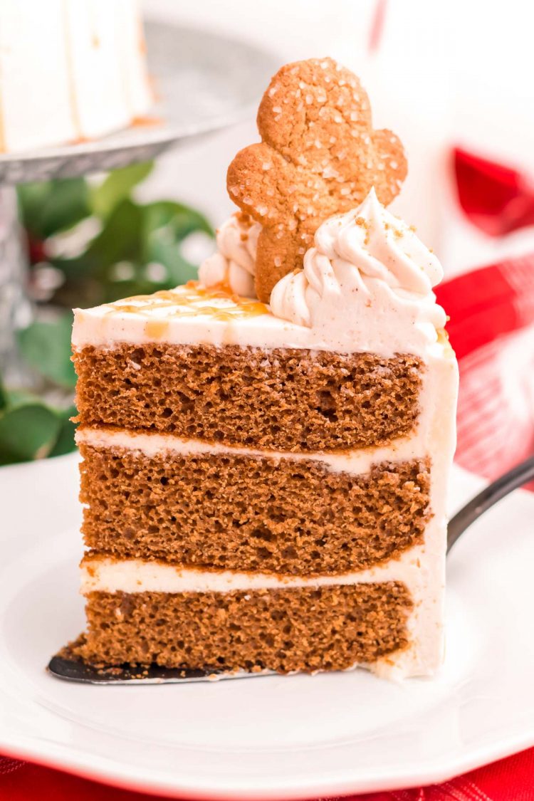 A slice of gingerbread cake on a white plate.