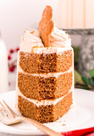 A slice of three layer gingerbread cake with a bite taken out of the front.