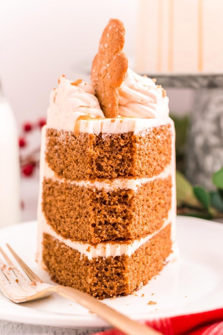 A slice of three layer gingerbread cake with a bite taken out of the front.