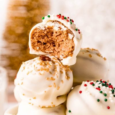 Close up photo of gingerbread truffles stacked in a white cup.