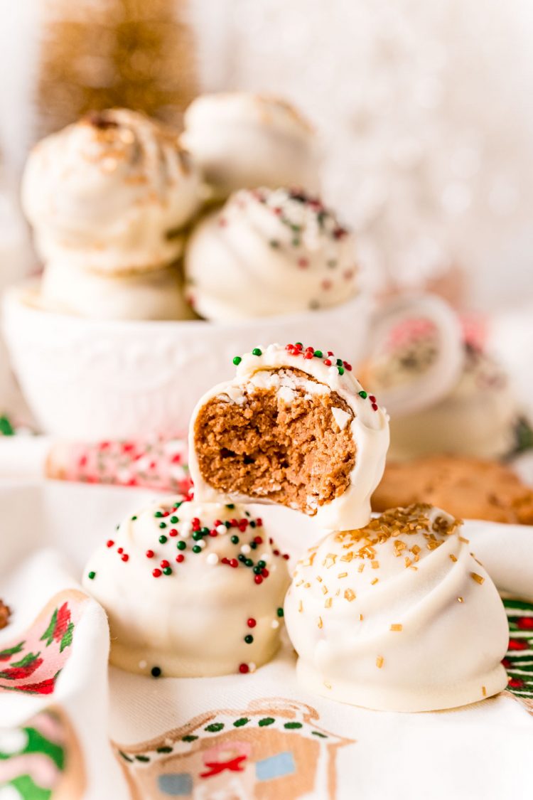 Three gingerbread balls stacked with the top ball having a bite taken out of it.