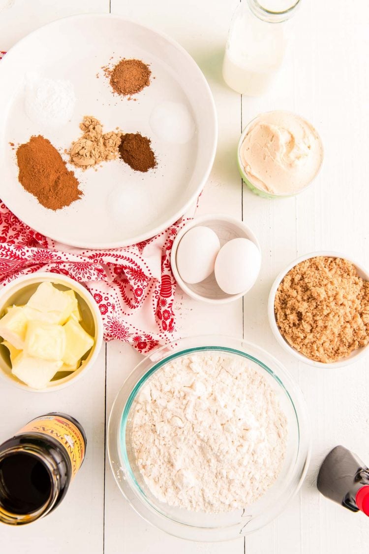 Overhead photo of ingredients to make gingerbread whoopie pies in prep bowls on a white table.