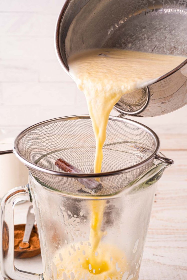 Eggnog being run through a strainer.