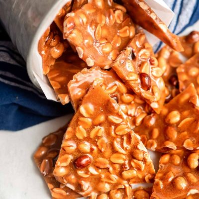 Peanut brittle coming out of a tin can.