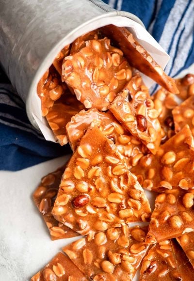 Peanut brittle coming out of a tin can.