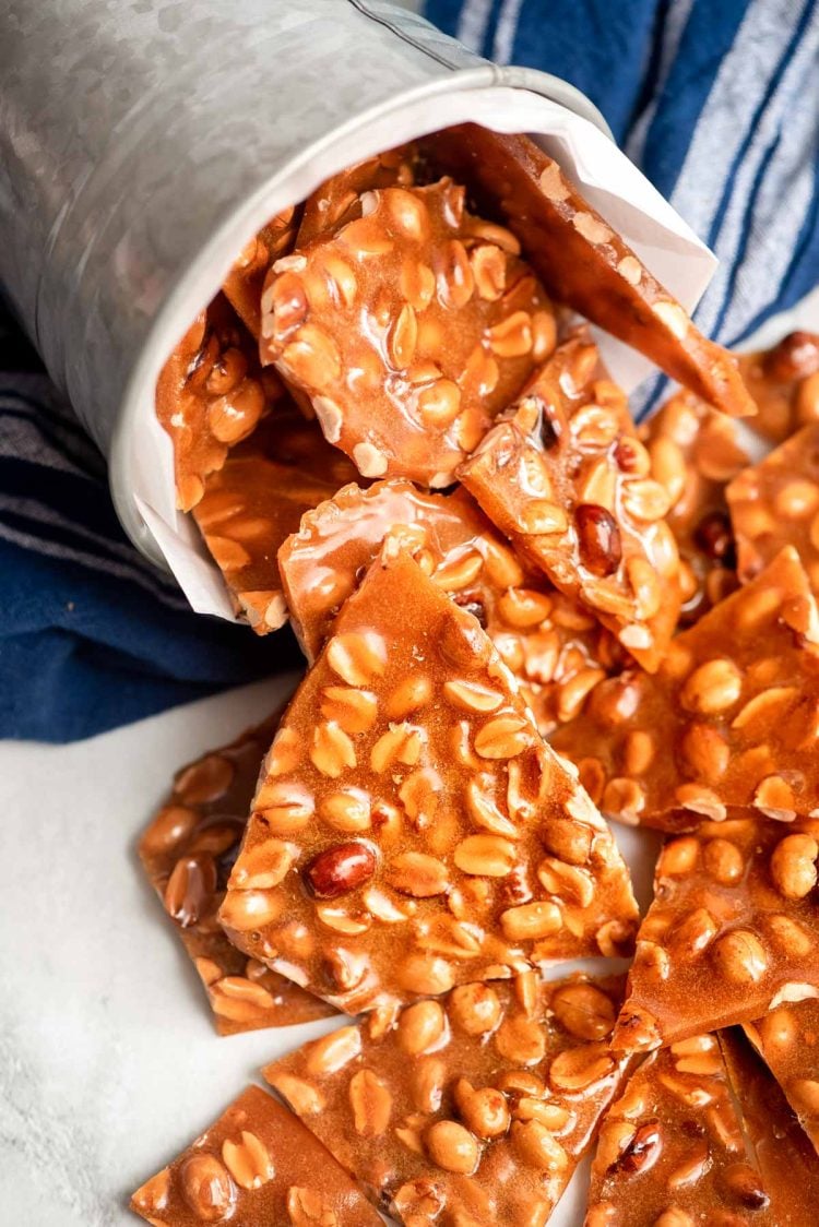 Peanut brittle coming out of a tin can.