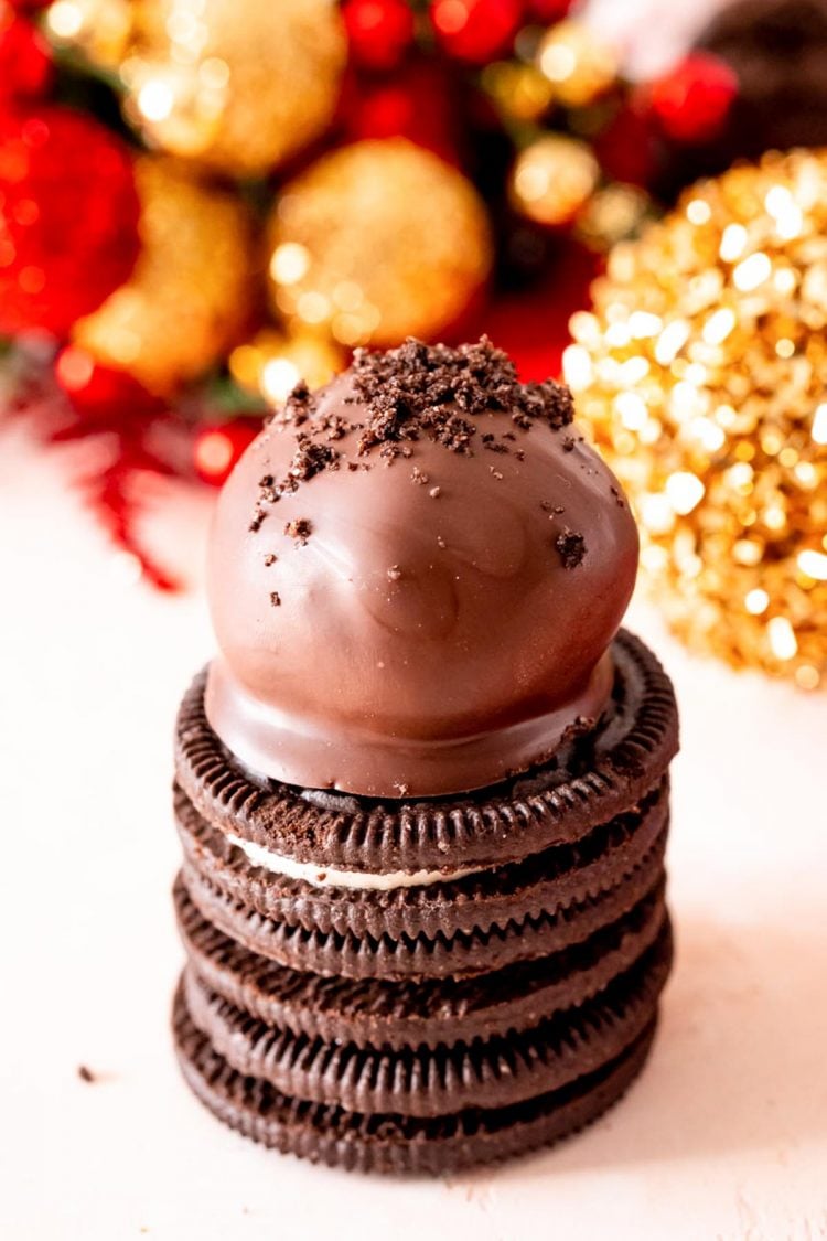 Oreo chocolate truffle on a stack of three oreos.