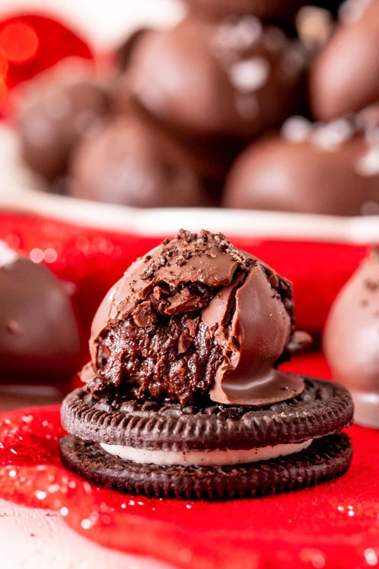 Oreo truffle with a bite taken out of it on an Oreo.