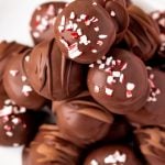 Close up photo of peppermint oreo truffles on a white plate.