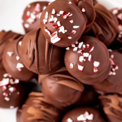 Close up photo of peppermint oreo truffles on a white plate.
