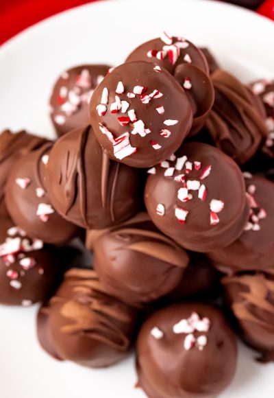 Close up photo of peppermint oreo truffles on a white plate.