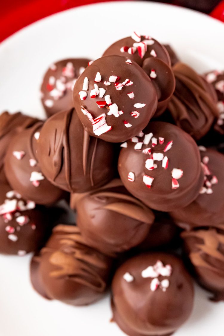 Close up photo of peppermint oreo truffles on a white plate.