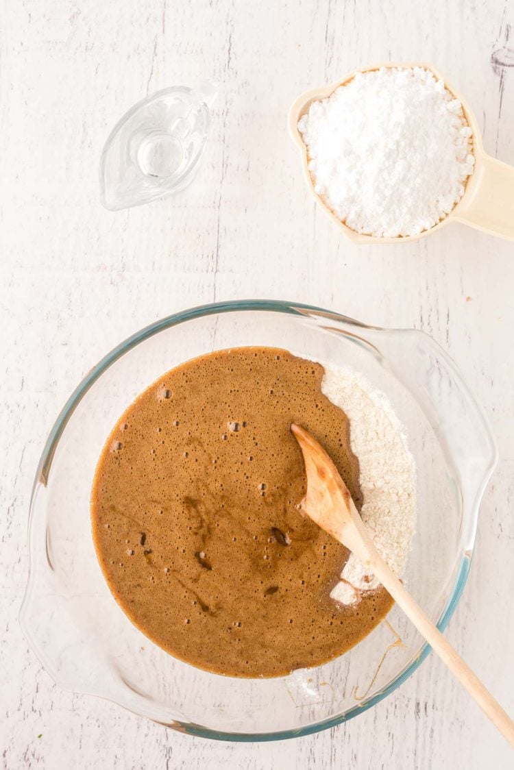 Ingredients being mixed in a glass mixing bowl to make cookies.