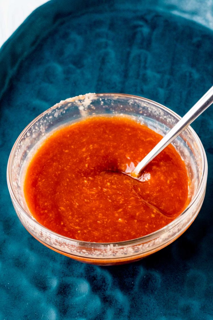 Shrimp cocktail sauce in a glass bowl with a fork.