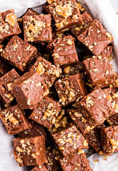 Overhead photo of a bunch of pieces of walnut chocolate fudge on a plate.