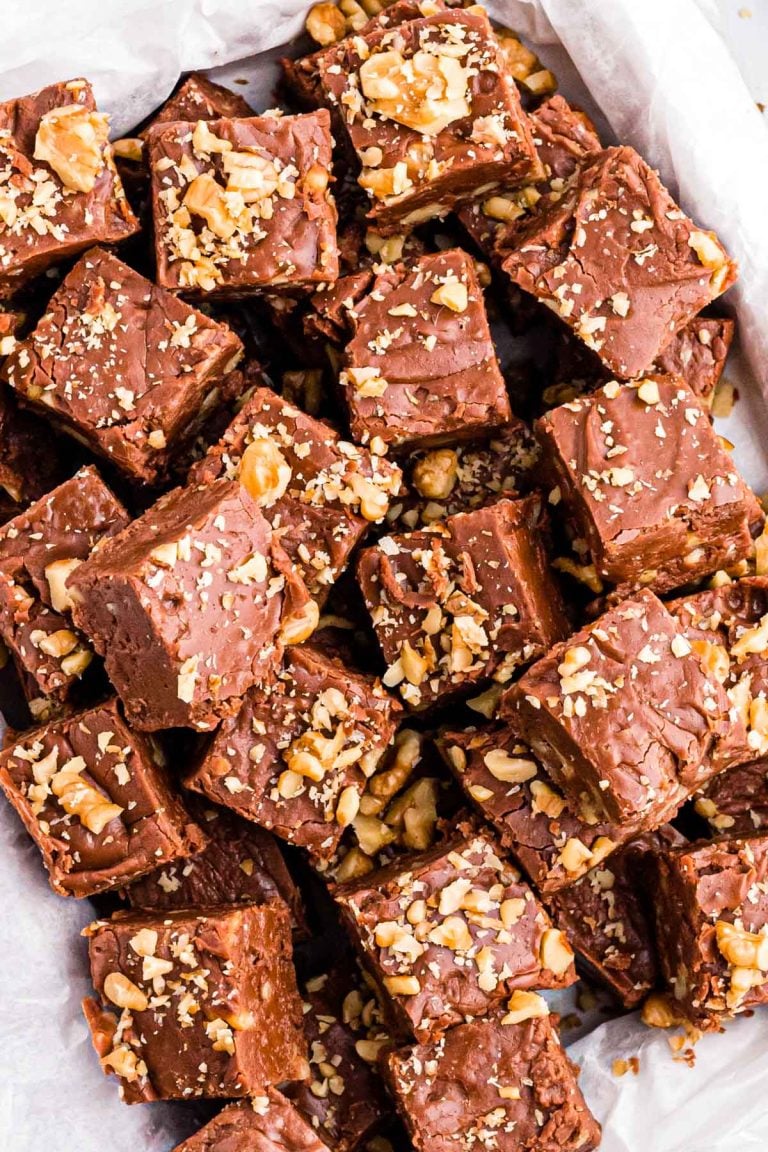 Overhead photo of a bunch of pieces of walnut chocolate fudge on a plate.