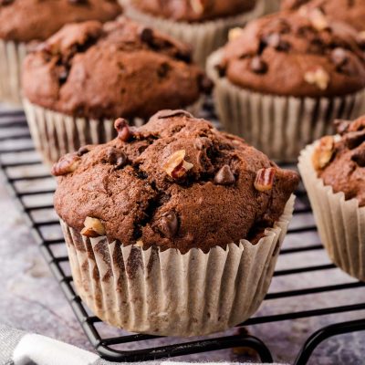 Chocolate Chip Banana Pecan muffins on a wire rack.