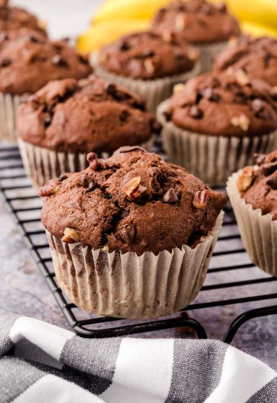 Chocolate Chip Banana Pecan muffins on a wire rack.