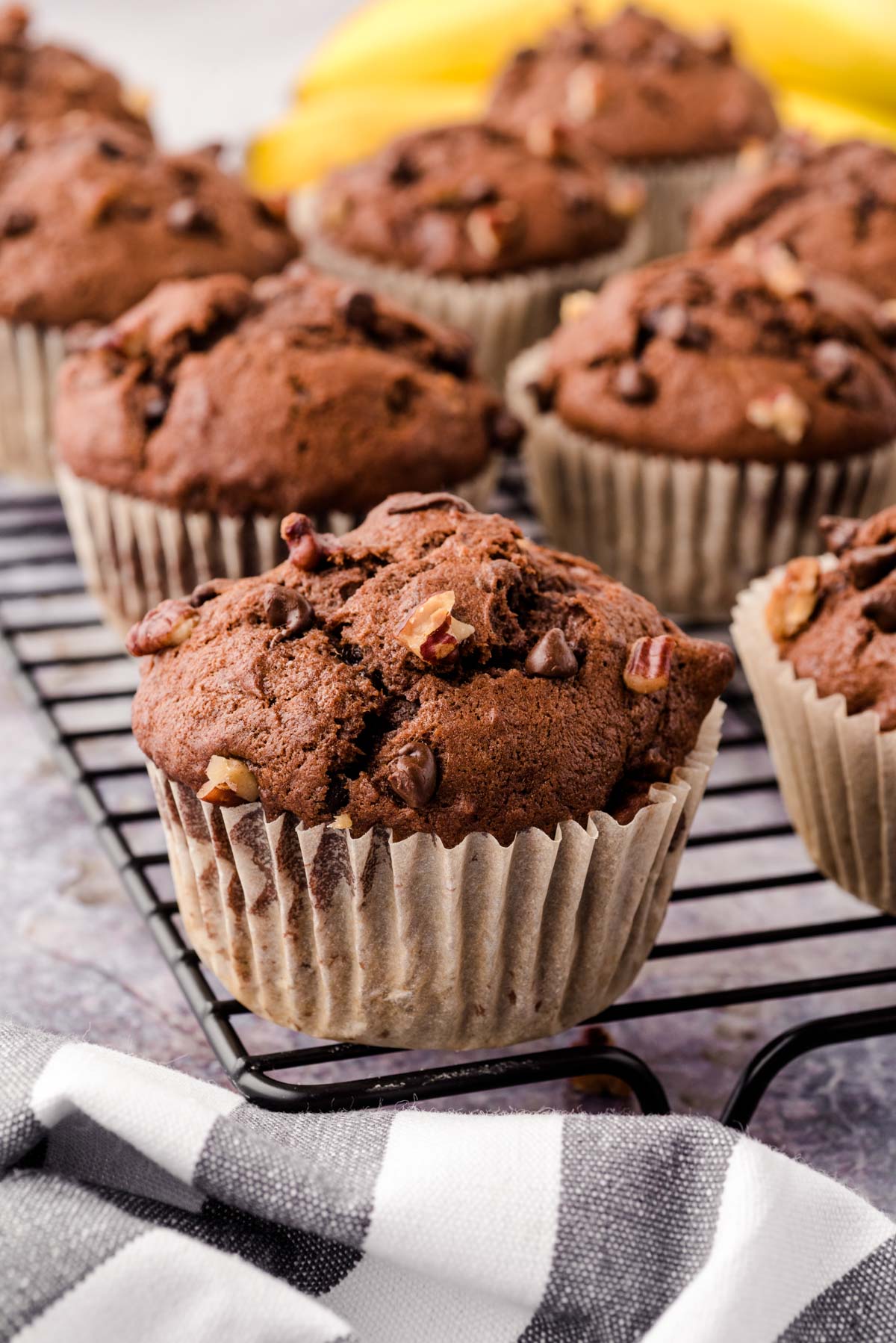 Chocolate Chip Banana Pecan muffins on a wire rack.