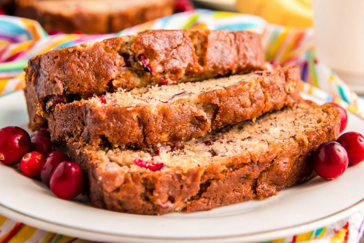 Close up photo of three slices of banana bread on a white plate.