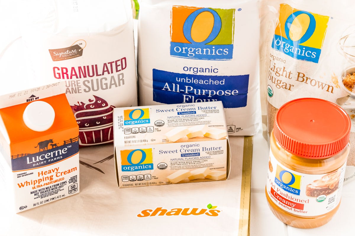 Ingredients to make edible peanut butter cookie dough on a white surface.