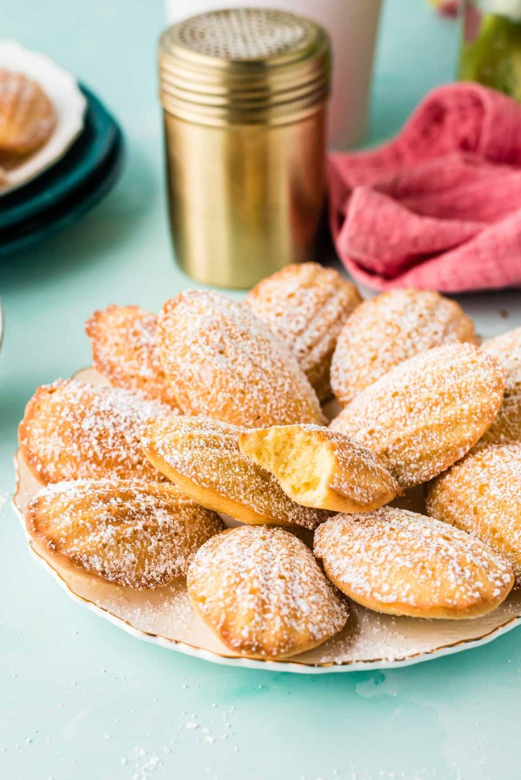 A plate of madeleines on a blue counter.
