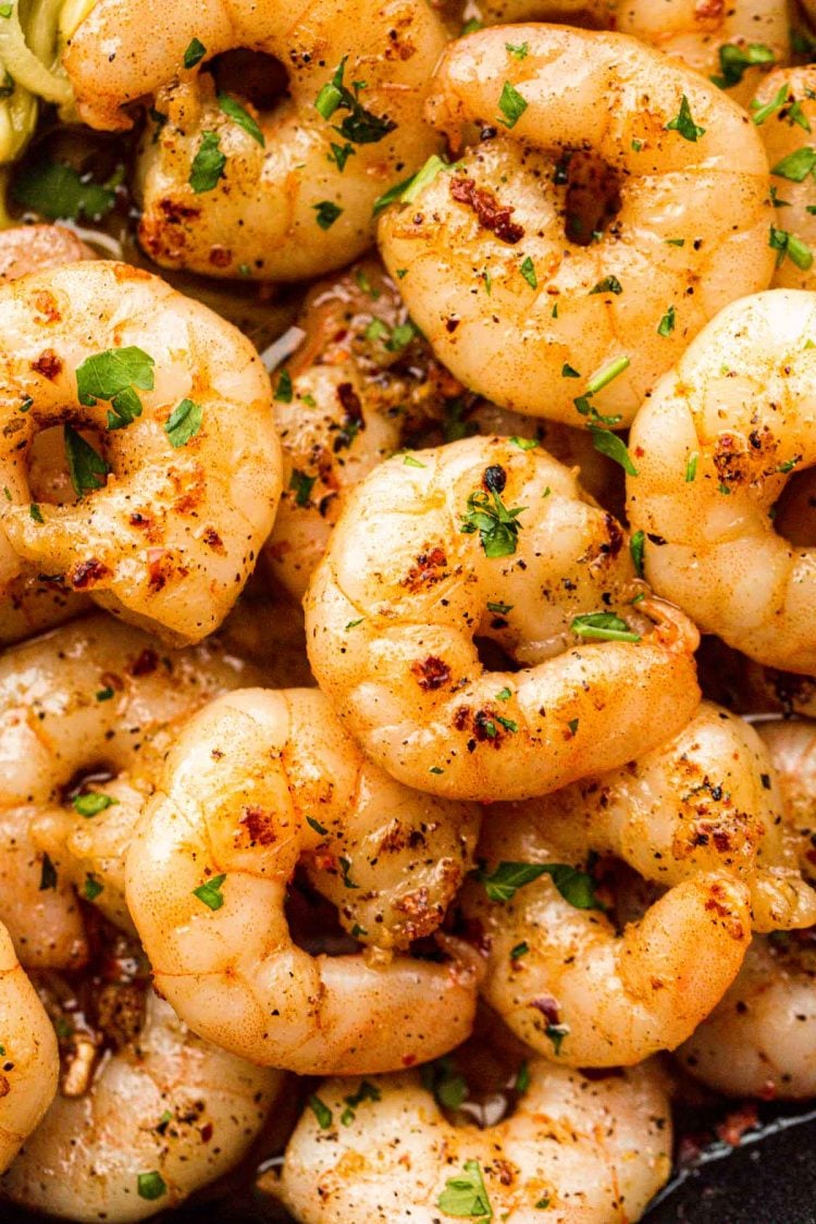 Close up photo of sauteed shrimp in a skillet.