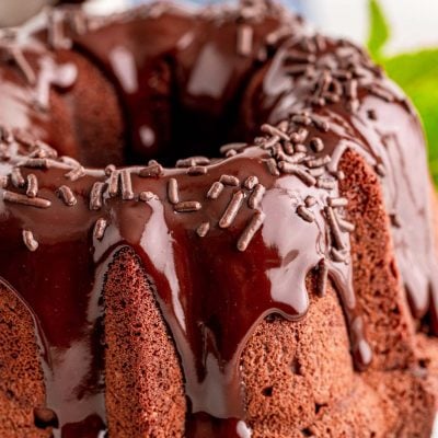 Close up photo of a chocolate bundt cake topped with ganache.