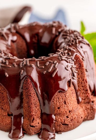 Close up photo of a chocolate bundt cake topped with ganache.