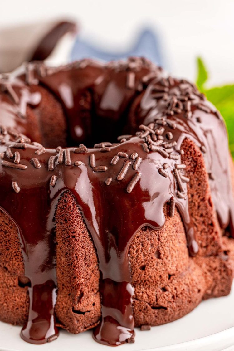 Close up photo of a chocolate bundt cake topped with ganache.