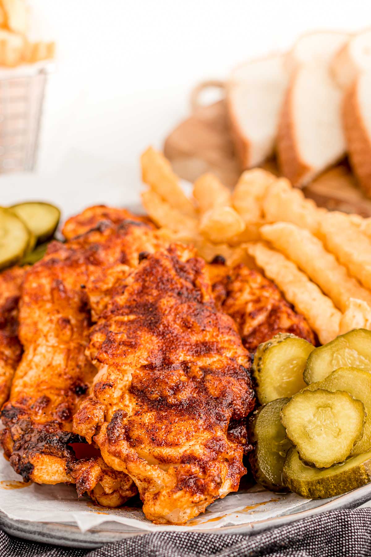Close up photo of Nashville hot chicken on a plate.