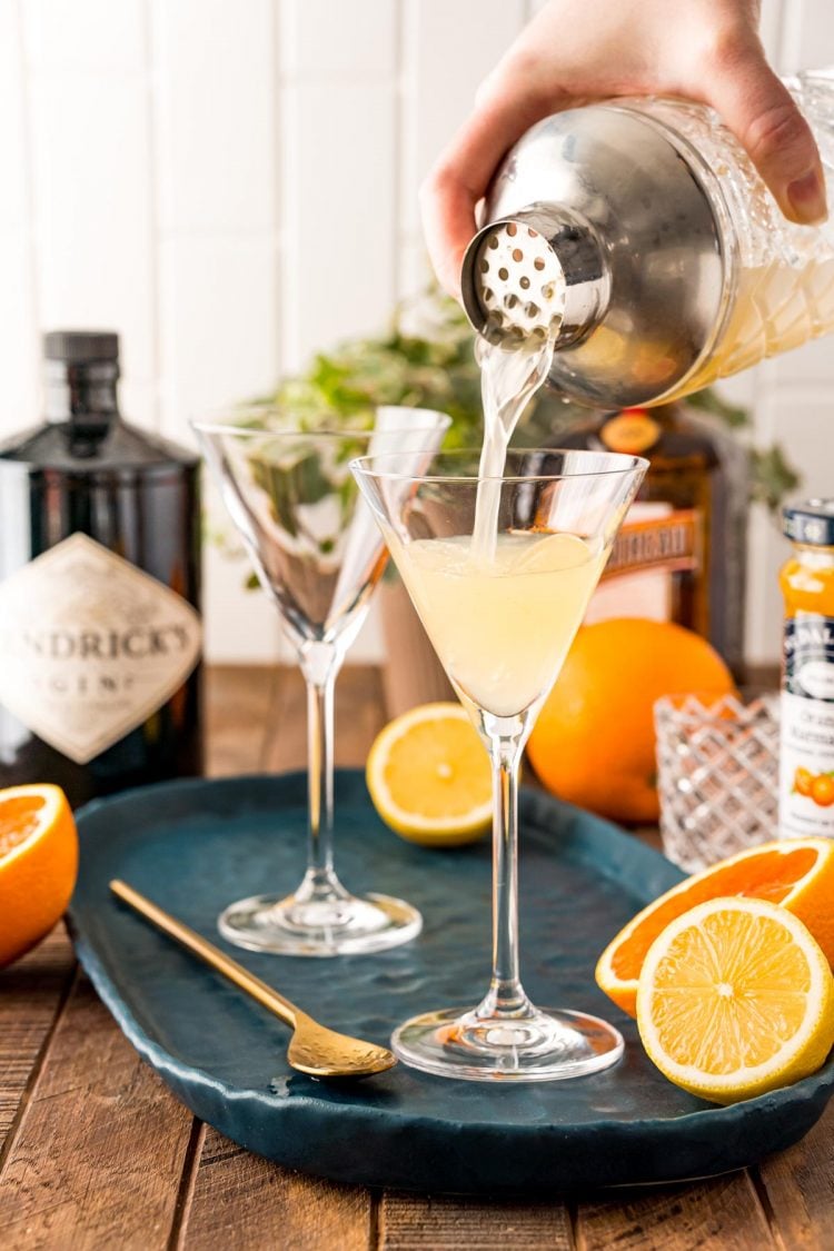 A breakfast martini being poured out of a cocktail shaker into a martini glass.