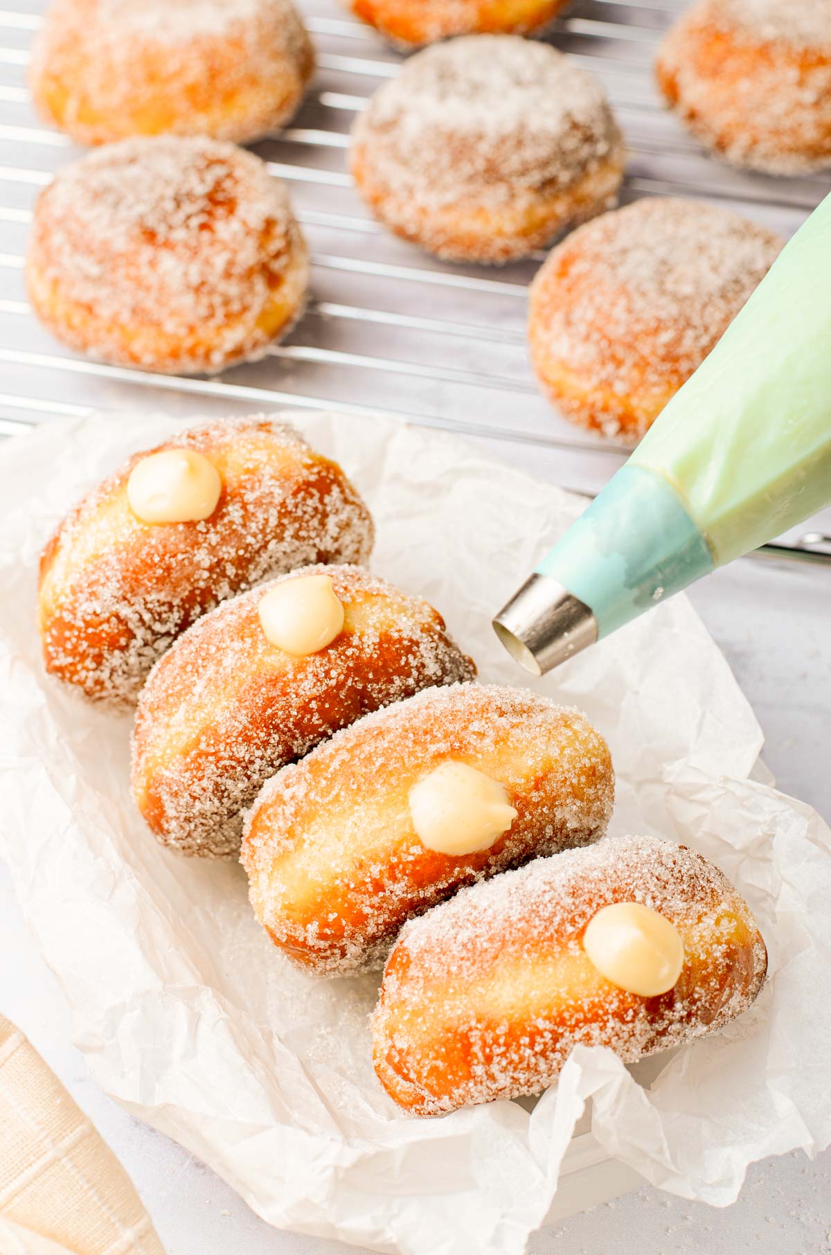 Brioche donuts filled with vanilla cream on a plate.