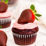 Close up photo of chocolate covered strawberry cupcakes on a white plate.