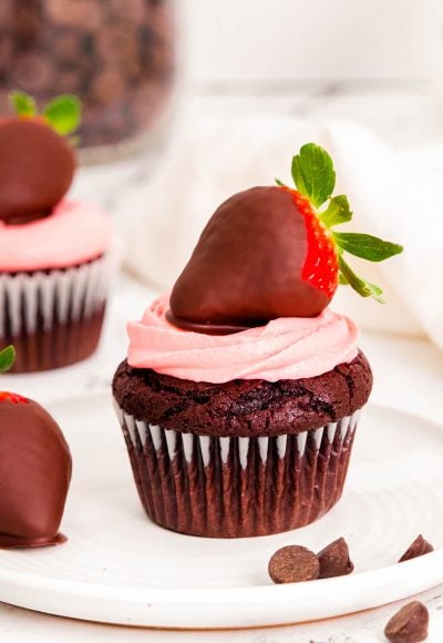 Close up photo of chocolate covered strawberry cupcakes on a white plate.