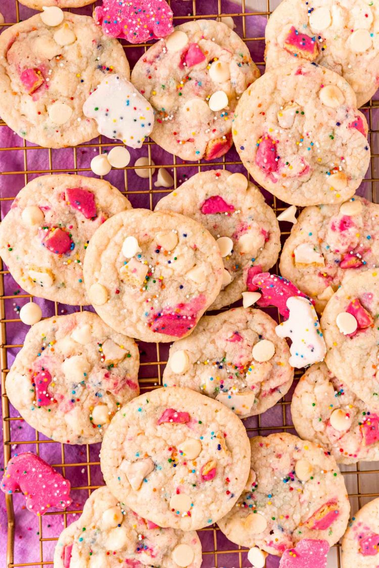 Overhead photo of a bunch of sugar cookies with circus animal cookies on a cooling rack.