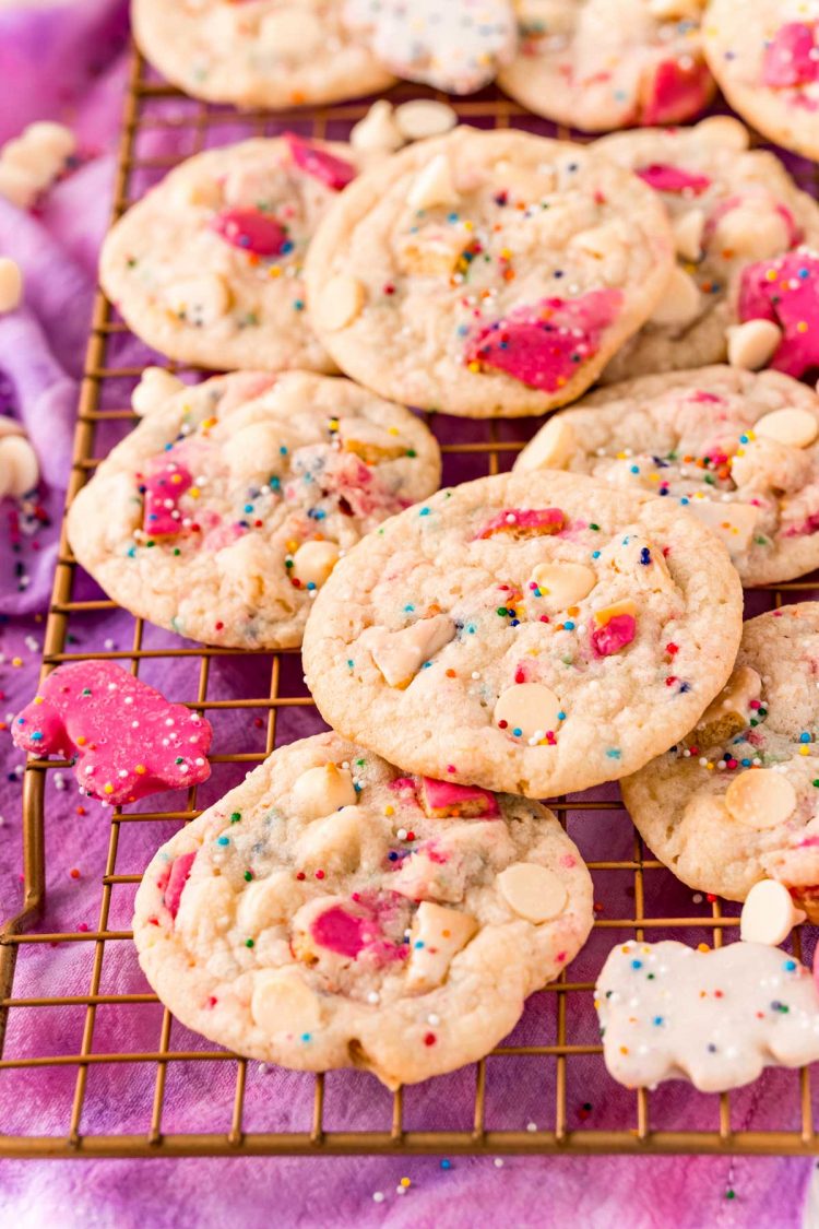 Close up photo of circus animal cookies on a wire rack on a purple napkin.