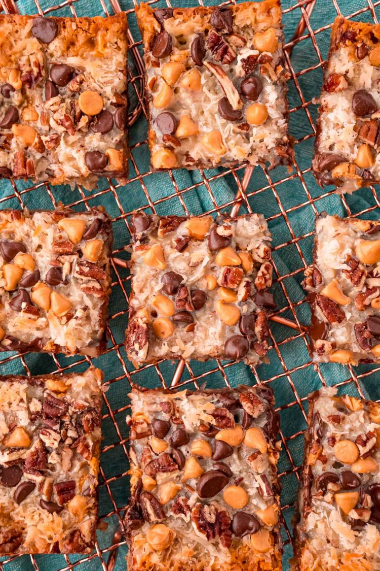 Overhead photo of sliced 7 layer bars on a copper wire rack.