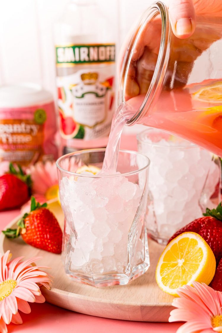 Hippie Juice being poured into a glass with ice.