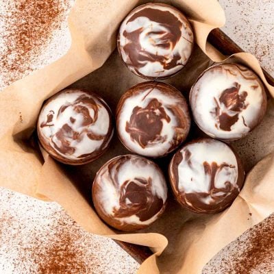 Overhead photo of mocha hot chocolate bombs in a pan with parchment paper.