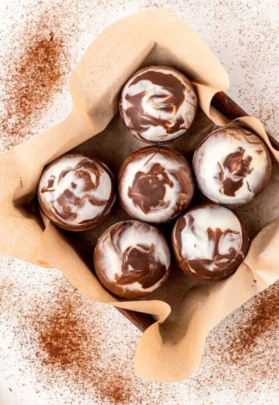 Overhead photo of mocha hot chocolate bombs in a pan with parchment paper.