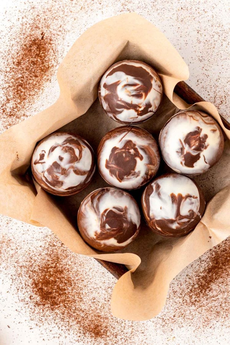 Overhead photo of mocha hot chocolate bombs in a pan with parchment paper.