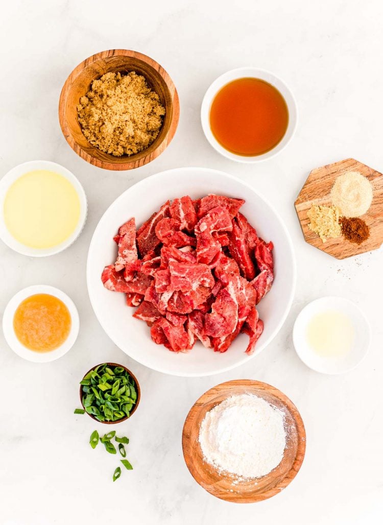 Overhead photo of ingredients prepped to make Mongolian beef on a white counter.