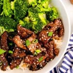 Overhead photo of mongolian beef with broccoli and rice in a white bowl.