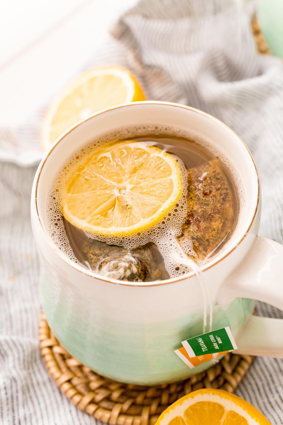 Close up photo of a mug with tea and lemonade in it.