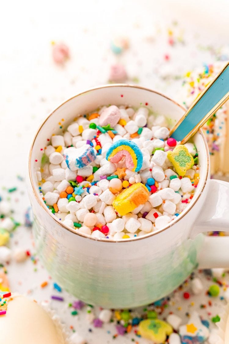 Close up photo of white hot chocolate with lucky charms marshmallows.