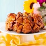 Close up photo of monkey bread on a white cake stand.
