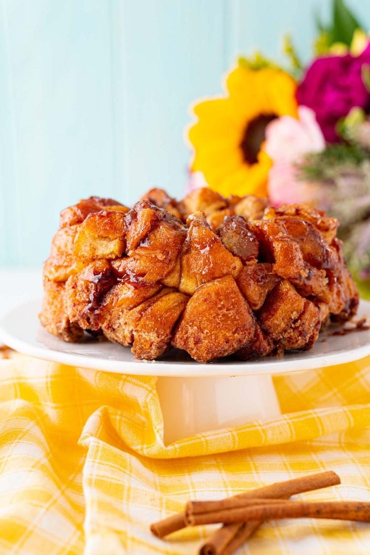 Close up photo of monkey bread on a white cake stand. 