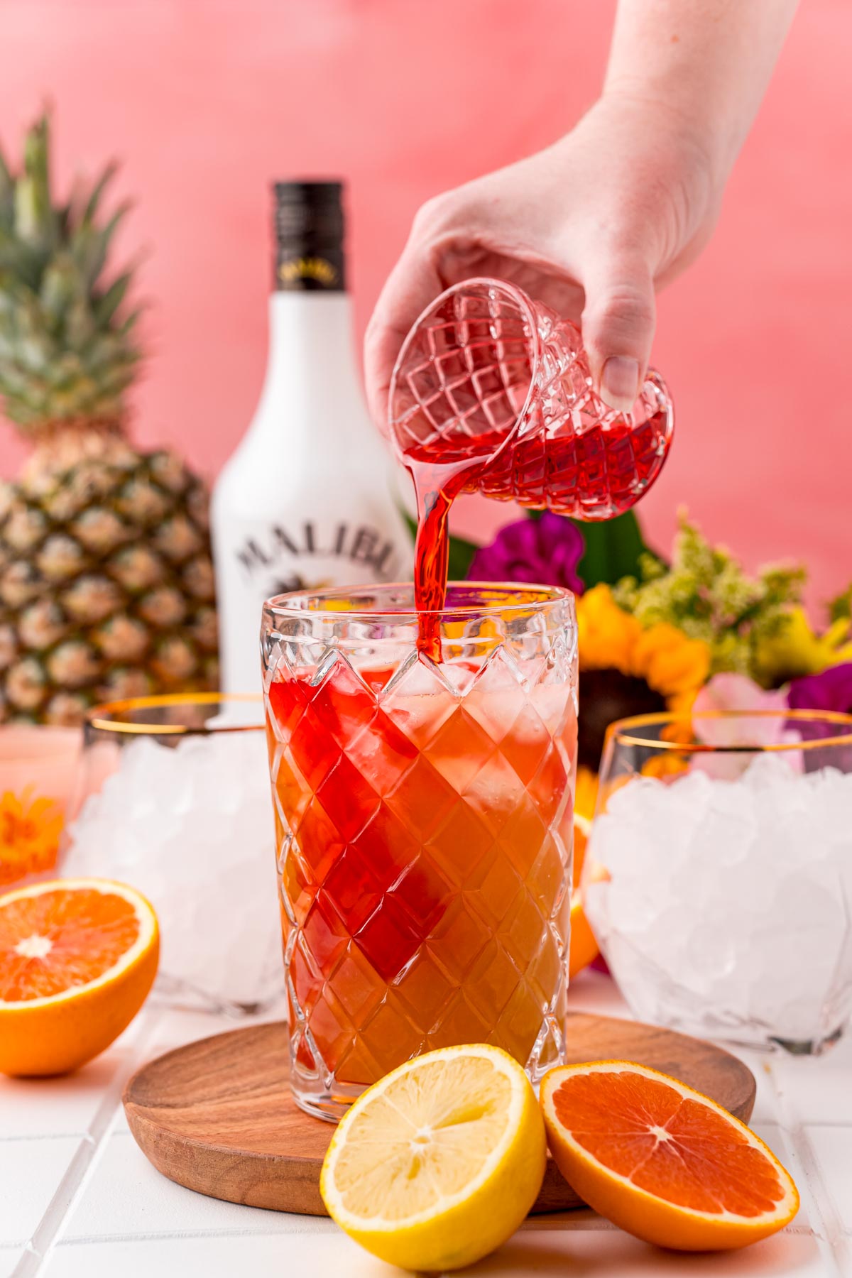 Grenadine being poured into a cocktail shaker.